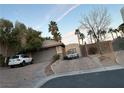 Charming single-story house with a paved driveway, mature trees, a garage, and a parked white car at 4738 Laurel Canyon St, Las Vegas, NV 89129