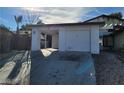 Single-story home with a two-car garage, white exterior, and desert landscaping at 4795 Via San Andros, Las Vegas, NV 89103