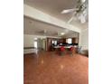 Spacious living room with terra cotta tile floors and an open layout connected to the kitchen at 4928 E Monroe Ave, Las Vegas, NV 89110