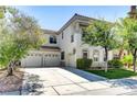 Beautiful two-story stucco home with a three-car garage and well-maintained landscaping at 52 Cascade Lake St, Las Vegas, NV 89148