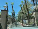 View from inside gated entrance to condo complex, showcasing landscaping at 5250 S Rainbow Blvd # 1010, Las Vegas, NV 89118