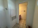 View into the downstairs bathroom, with pink vanity and beige tile floors at 6250 W Flamingo Rd # 157, Las Vegas, NV 89103