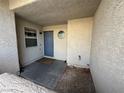 View of the front entrance, with blue door, small window, and small round window above at 6250 W Flamingo Rd # 157, Las Vegas, NV 89103