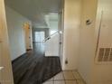 Hallway with wood-look floors leading to the living room and stairs going to the second floor at 6250 W Flamingo Rd # 157, Las Vegas, NV 89103