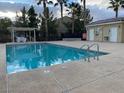Relaxing community pool with lounge chairs, jacuzzi and pool house for residents to enjoy at 6316 Beige Bluff St # 201, North Las Vegas, NV 89081