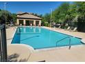 Community pool with lounge chairs, surrounded by well-maintained landscaping at 8324 W Charleston Blvd # 2033, Las Vegas, NV 89117