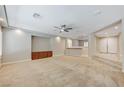 Comfortable living area featuring carpet, built-in shelving, recessed lighting and half wall to kitchen at 8453 Moondance Cellars Ct, Las Vegas, NV 89139
