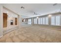 Spacious living room featuring a ceiling fan, carpet, and multiple windows providing ample natural light at 8453 Moondance Cellars Ct, Las Vegas, NV 89139