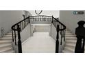 Elegant foyer with grand staircase and open layout, offering a sophisticated entrance at 8809 Barium Rock Ave, Las Vegas, NV 89143