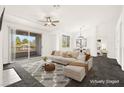 Bright living room boasts a large window, ceiling fan, and a sliding door to the balcony at 913 Duckhorn Ct # 204, Las Vegas, NV 89144