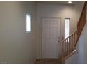 Bright entryway featuring a staircase with wooden handrail and a decorative window at 10371 Calypso Cave St, Las Vegas, NV 89141