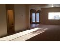 Spacious living room area with natural light and double doors to the exterior at 10371 Calypso Cave St, Las Vegas, NV 89141