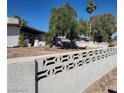 Home with a decorative concrete fence, mature landscaping, and a spacious front yard at 1413 Bryn Mawr Ave, Las Vegas, NV 89102