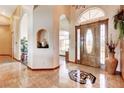 Elegant foyer with decorative tile inlay, arched doorways and a statement front door at 1440 Lost Creek Dr, Pahrump, NV 89048