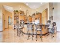 Open kitchen featuring a center island with bar seating, custom cabinetry, and tile floors at 1440 Lost Creek Dr, Pahrump, NV 89048