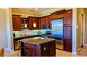 Gourmet kitchen featuring a large island, stainless steel appliances, and granite countertops at 16 Via Visione # 102, Henderson, NV 89011