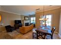 Living room features a stone fireplace, comfortable seating, and sliding glass door leading to the backyard at 16 Via Visione # 102, Henderson, NV 89011
