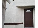 A close-up of a solid brown front door with a decorative window and matching trim at 1936 St Lawrence Dr, Las Vegas, NV 89108