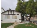 Inviting single-story home with maintained lawn, mature trees, and neutral color scheme at 1936 St Lawrence Dr, Las Vegas, NV 89108