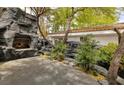 Outdoor stone fireplace and patio create an entertainer's dream backyard at 2221 S Tioga Way, Las Vegas, NV 89117