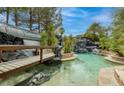 Stunning pool area with a bridge, waterfall, and lush greenery, perfect for relaxation at 2221 S Tioga Way, Las Vegas, NV 89117