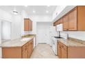 Well-lit kitchen featuring granite countertops, ample cabinetry, and white appliances at 2615 W Gary Ave # 1041, Las Vegas, NV 89123