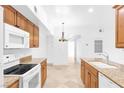 Bright kitchen with granite countertops, white appliances, and wood cabinets at 2615 W Gary Ave # 1041, Las Vegas, NV 89123