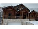 Charming log home with a stone base, covered entry, and natural wood accents at 311 Crestview Dr, Las Vegas, NV 89124