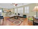 Bright living room featuring a seamless flow into the kitchen, with hardwood floors and plantation shutters on the windows at 337 Mattie Brook Ave, Henderson, NV 89015