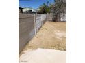 An empty backyard features a cement fence line with a dirt ground at 3601 Valley Forge Ave, Las Vegas, NV 89110
