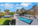 Private backyard oasis includes pool and tennis court at 3860 Hildebrand Ln, Las Vegas, NV 89121