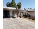 Exterior view showing the covered parking and front yard of the home at 3908 Montebello Ave, Las Vegas, NV 89110