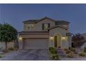 Beautiful two-story home featuring a brick driveway, a well-manicured lawn, and a two-car garage at 426 Port Reggio St, Las Vegas, NV 89138