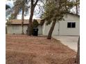 Home exterior with mature trees and a desert landscape at 4341 San Mateo St, North Las Vegas, NV 89032