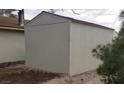 Exterior view of a detached garage or storage shed with vertical siding at 4341 San Mateo St, North Las Vegas, NV 89032