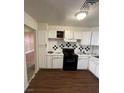 The kitchen features white cabinets, black appliances, and checkered backsplash at 4341 San Mateo St, North Las Vegas, NV 89032