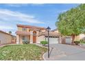 Charming two-story home features a landscaped front yard, attached garage, and inviting entryway at 4900 Whisper Lake Ave, Las Vegas, NV 89131