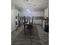 Well-lit kitchen with white cabinetry, stainless steel appliances, and tile backsplash at 4900 Whisper Lake Ave, Las Vegas, NV 89131