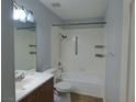 Bathroom with combined tub and shower, stylish vanity, and neutral color palette at 5044 S Rainbow Blvd # 106, Las Vegas, NV 89118