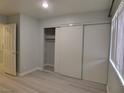 Bedroom with a large closet, light gray paint, and wood-look flooring at 5044 S Rainbow Blvd # 106, Las Vegas, NV 89118