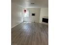 Neutral living space with a fireplace, a window, and modern flooring at 5044 S Rainbow Blvd # 106, Las Vegas, NV 89118