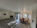 Open living area with fireplace, table, and sliding glass door leading to outdoor space at 5044 S Rainbow Blvd # 106, Las Vegas, NV 89118