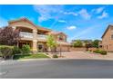 Charming home featuring a balcony, three-car garage, and well-manicured front lawn at 5872 Revital Ct, Las Vegas, NV 89131