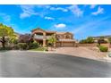 Charming two-story home featuring a balcony, three-car garage, and well-manicured landscaping at 5872 Revital Ct, Las Vegas, NV 89131