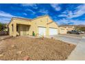 Single-story home with a two-car garage, desert landscaping, and a long driveway at 5934 Reflection Point Ct, Las Vegas, NV 89110