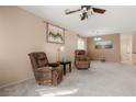 Cozy living room featuring neutral walls, plush carpeting, and comfortable reclining chairs at 5934 Reflection Point Ct, Las Vegas, NV 89110