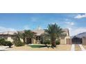 Charming home with tile roof, desert landscaping, and a gated driveway entrance at 6120 Matisse Ave, Las Vegas, NV 89131
