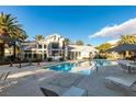 Inviting community pool with lounge chairs, tables, and umbrellas for relaxing poolside at 6134 Pine Villa Ave # 103, Las Vegas, NV 89108