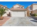 Two-story home boasts a two-car garage and a well-maintained driveway at 6328 Brianna Peak Ct, Las Vegas, NV 89142
