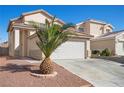 Two-story home boasts a two-car garage and a well-maintained driveway, surrounded by desert landscaping at 6328 Brianna Peak Ct, Las Vegas, NV 89142